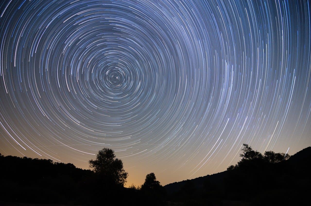 Star trails over a landscape at night